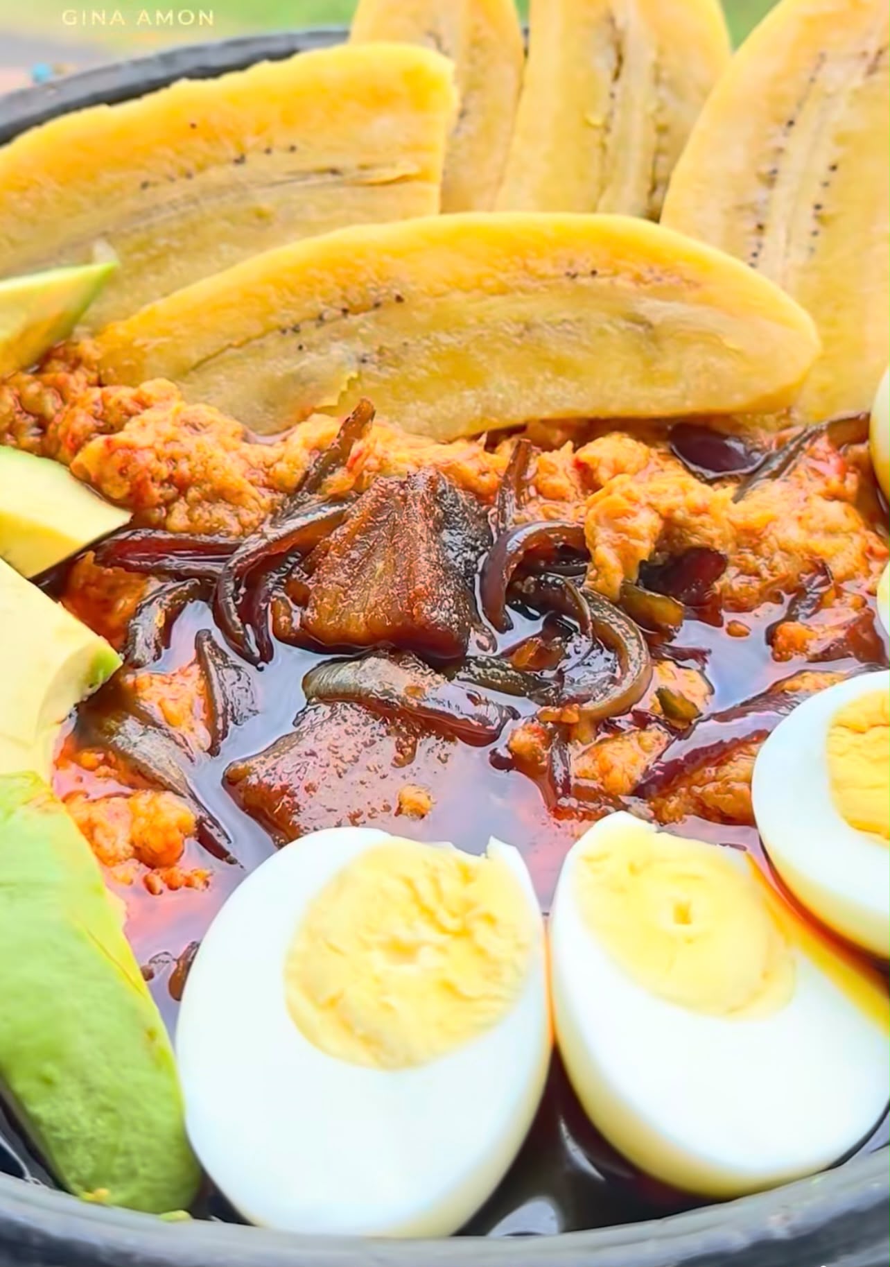 Ghanaian red red stew served with fried plantain, eggs and avocado