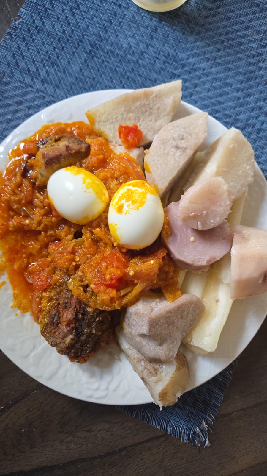 Ghanaian ampesi served with garden egg stew, eggs and fish