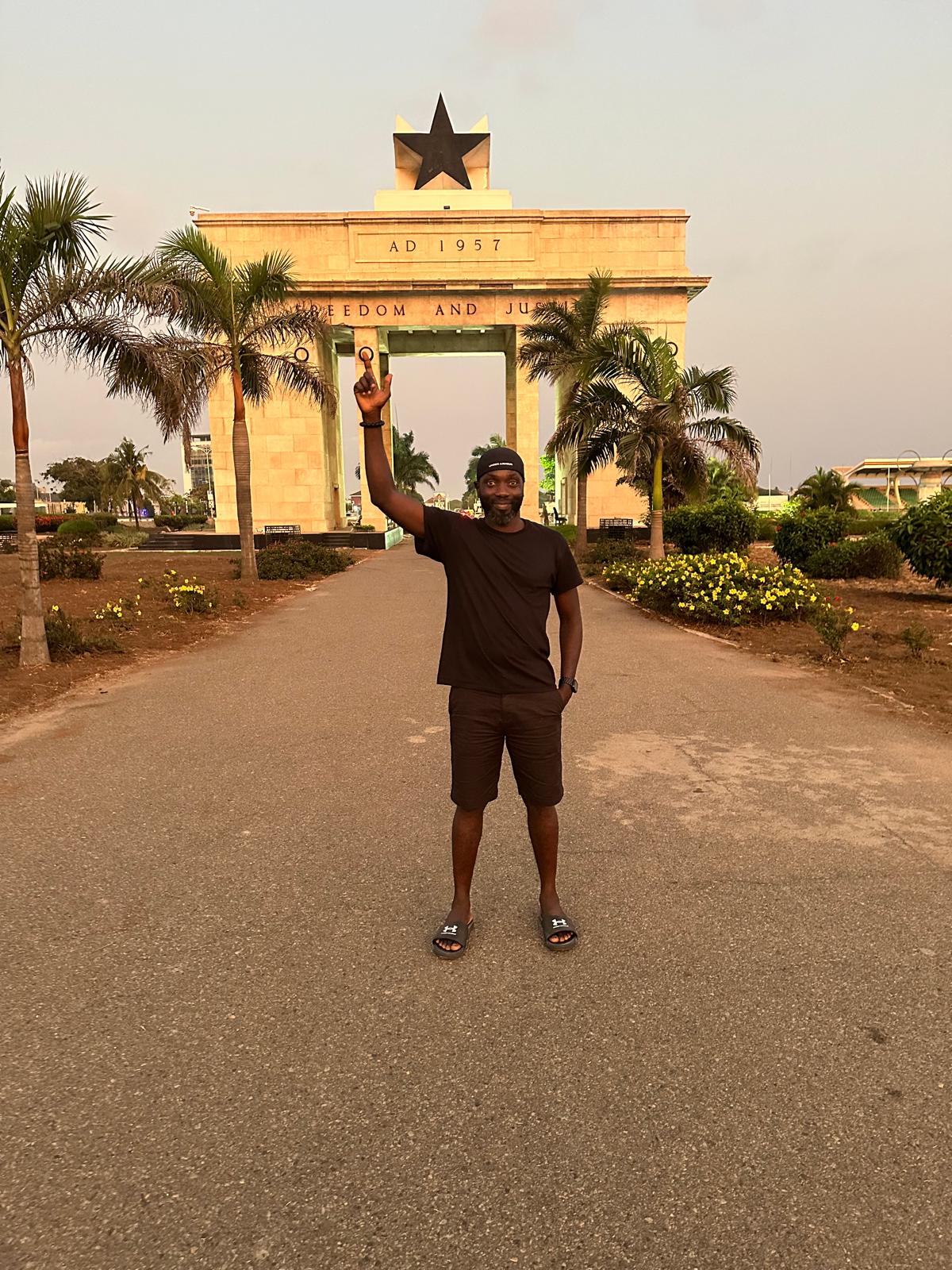 A visitor standing in front of the Black Star monument in Accra, Ghana