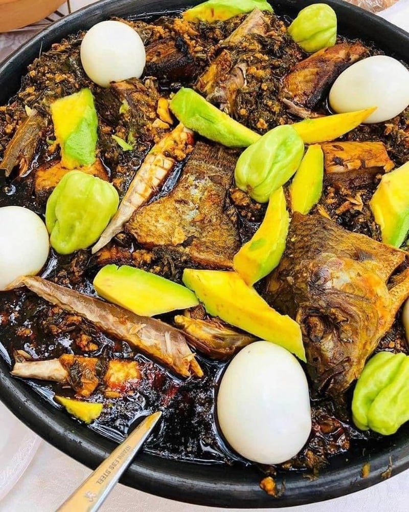Ghanaian kontomire stew served with fish, eggs and avocado
