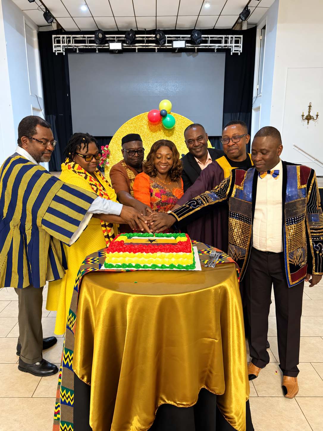 Community leaders cutting a Ghana-themed celebration cake